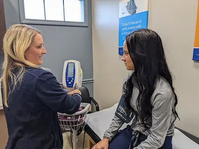 pre-teen getting their blood pressure tested