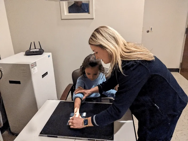 Nurse providing xray services to child