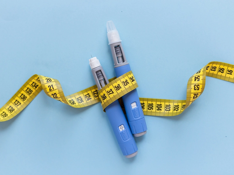 Semaglutide pens with a measuring tape wrapped around them